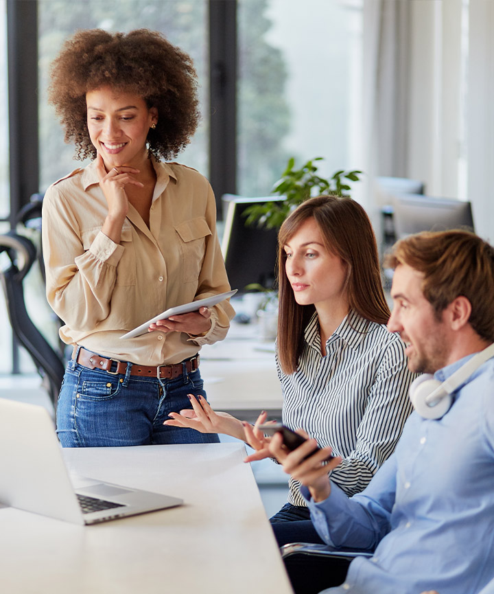 Three persons discussing marketing and sales strategy.
