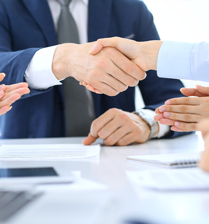 Two person shaking hands over a GSA Shedule Contract.